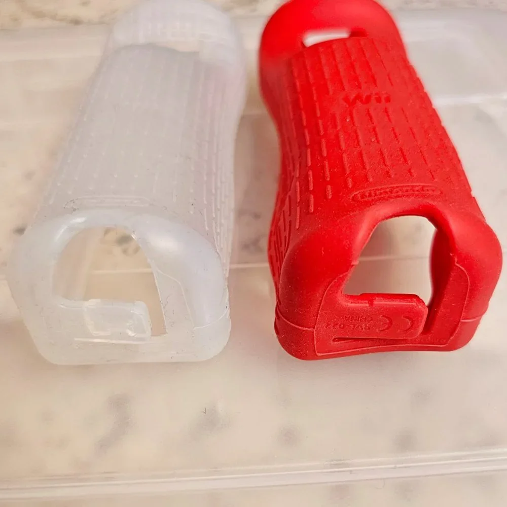 2 Wii silicone controller cases, EUC condition, OEM Nintendo, 1 red, 1 clear